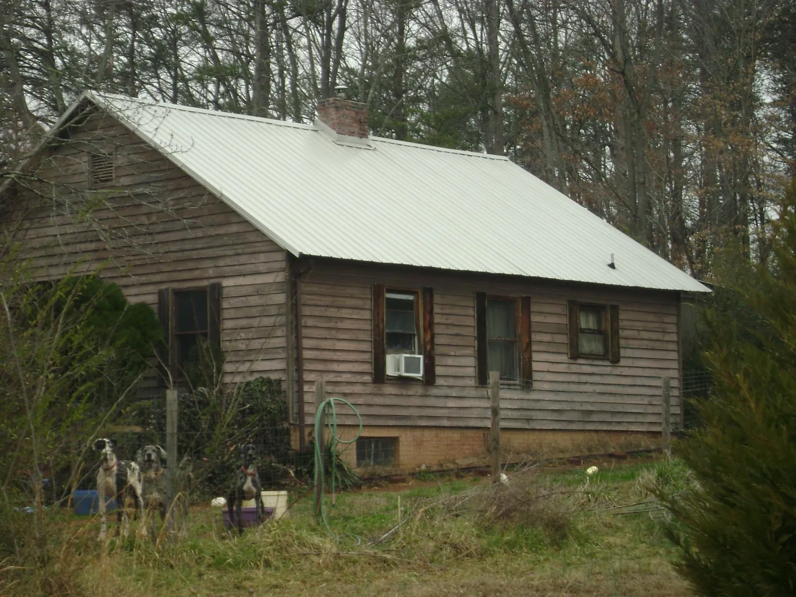 White metal roof on an old wood sided farmhouse, from a Metal Roof Installation job in Little Plymouth